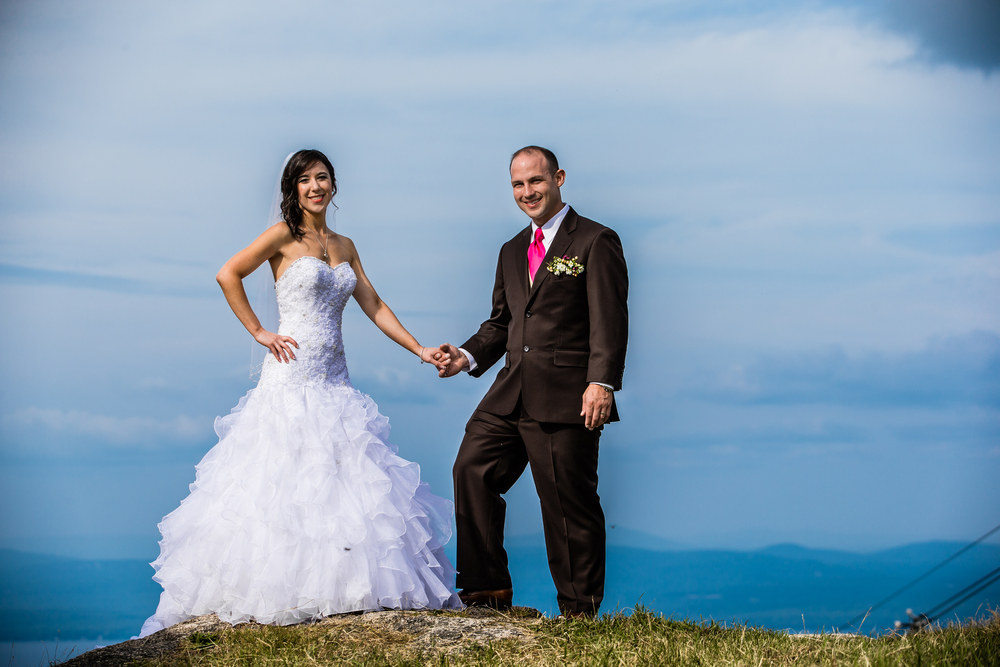 Summit wedding with couple overlooking Lake Winnipesaukee