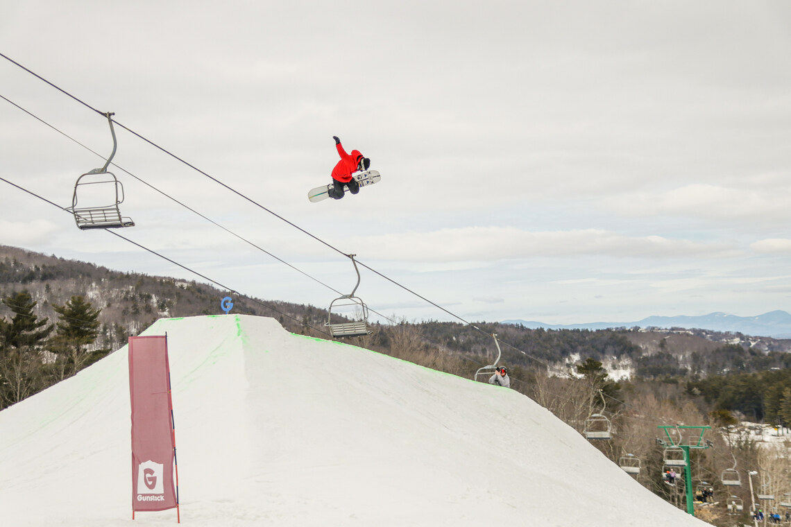 Snowboarder soars over a jump.