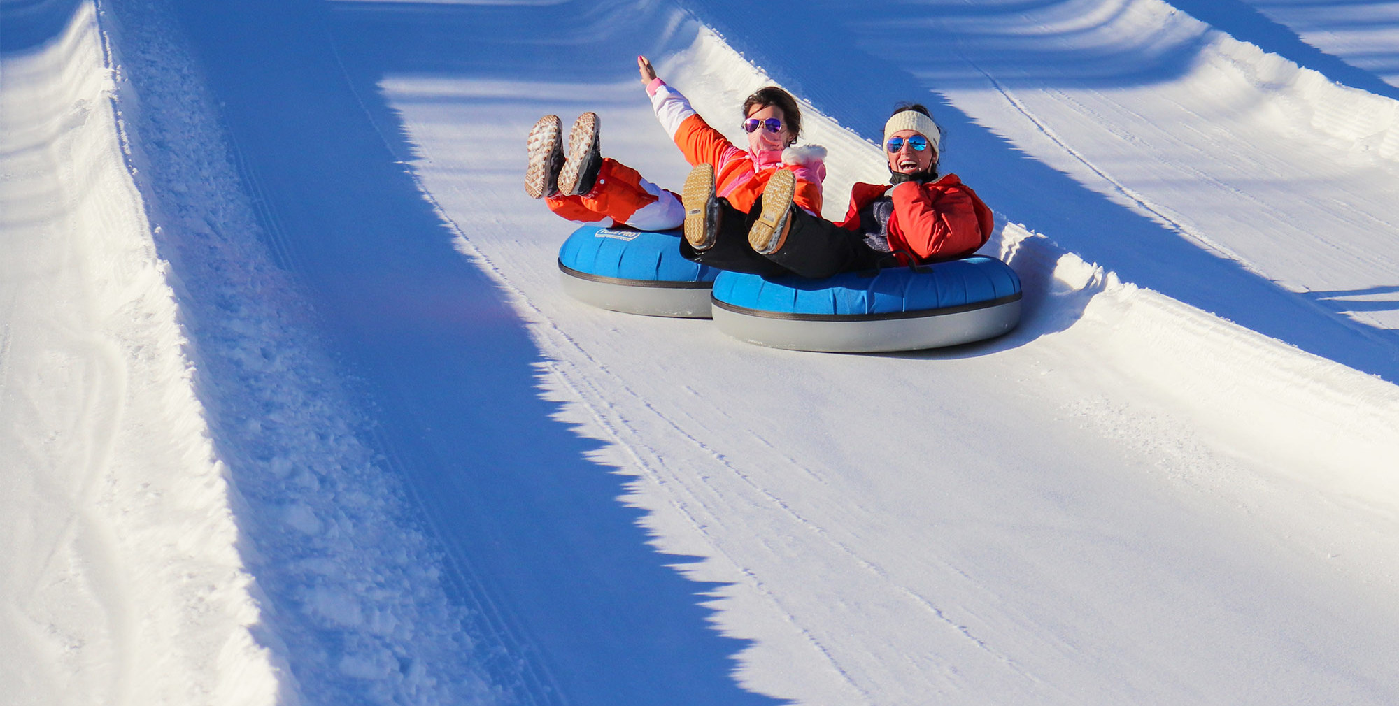 A family at the top of the tubing hill.