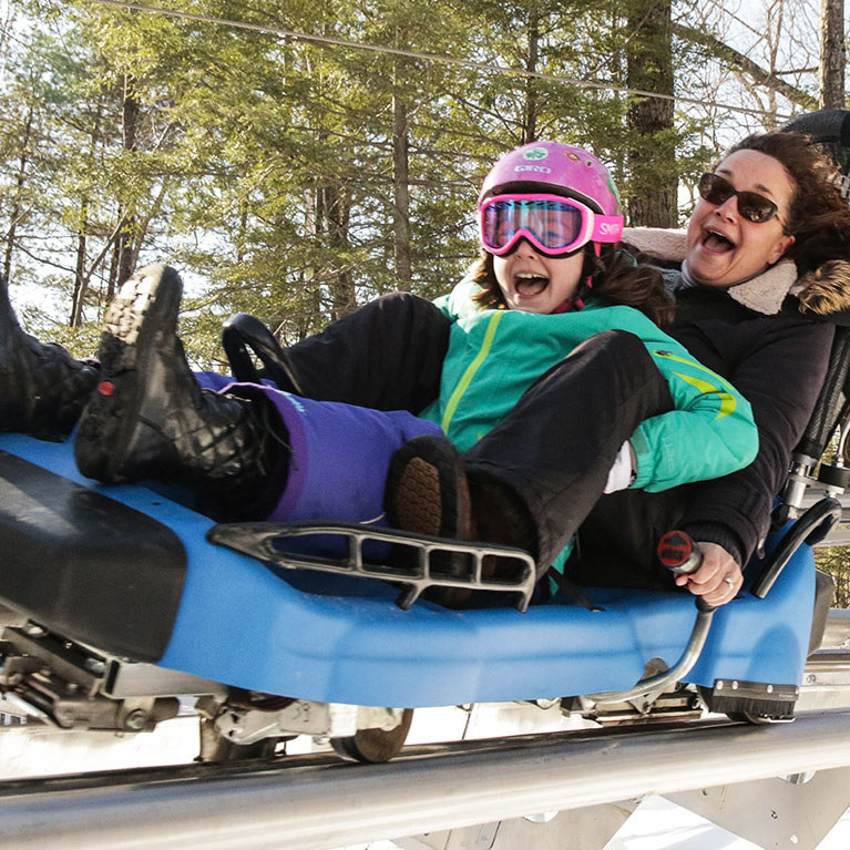 Mother and daughter on the Mountain Coaster during winter season